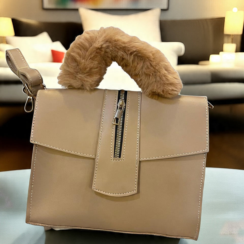 Beige handbag with fur handle on a table in a living room setting