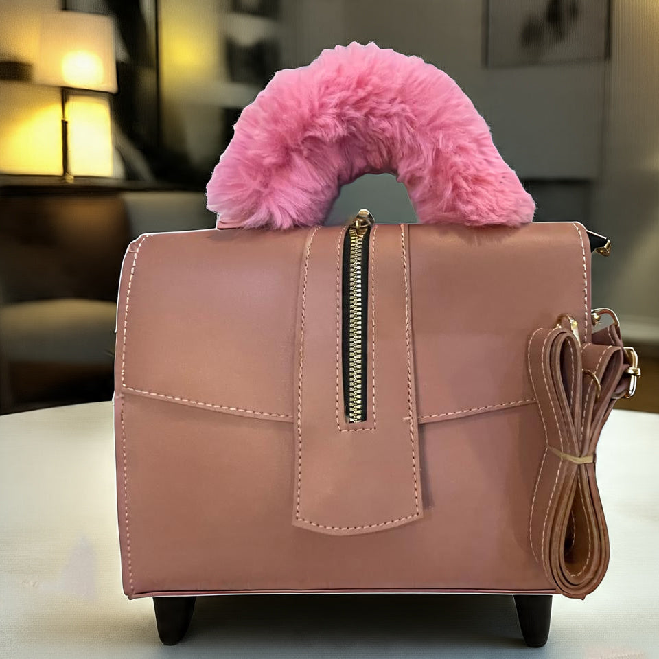 Bold Pink handbag with a fluffy pink handle on a blurred indoor background